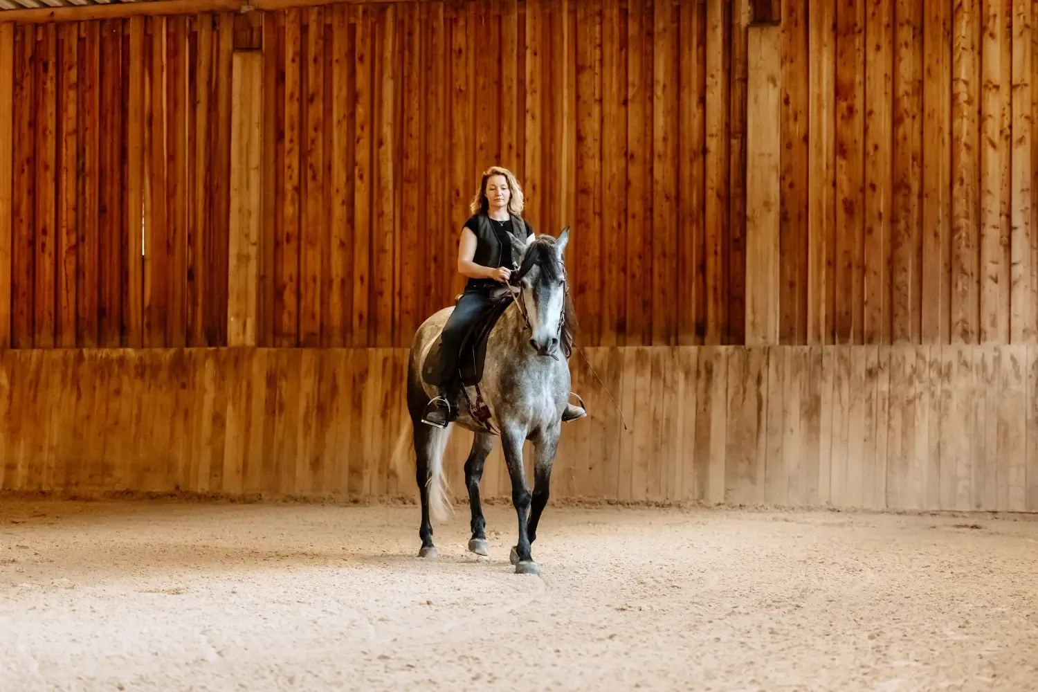Franziska Bode gibt Reitunterricht auf dem Schimmel in der Halle